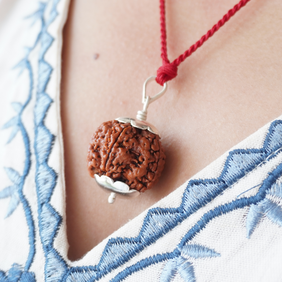 Red Thread 5 Mukhi Rudraksha pendant worn, close up