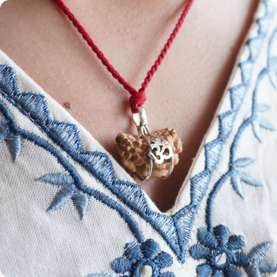 Red Thread 1 Mukhi Rudraksha pendant worn, close up