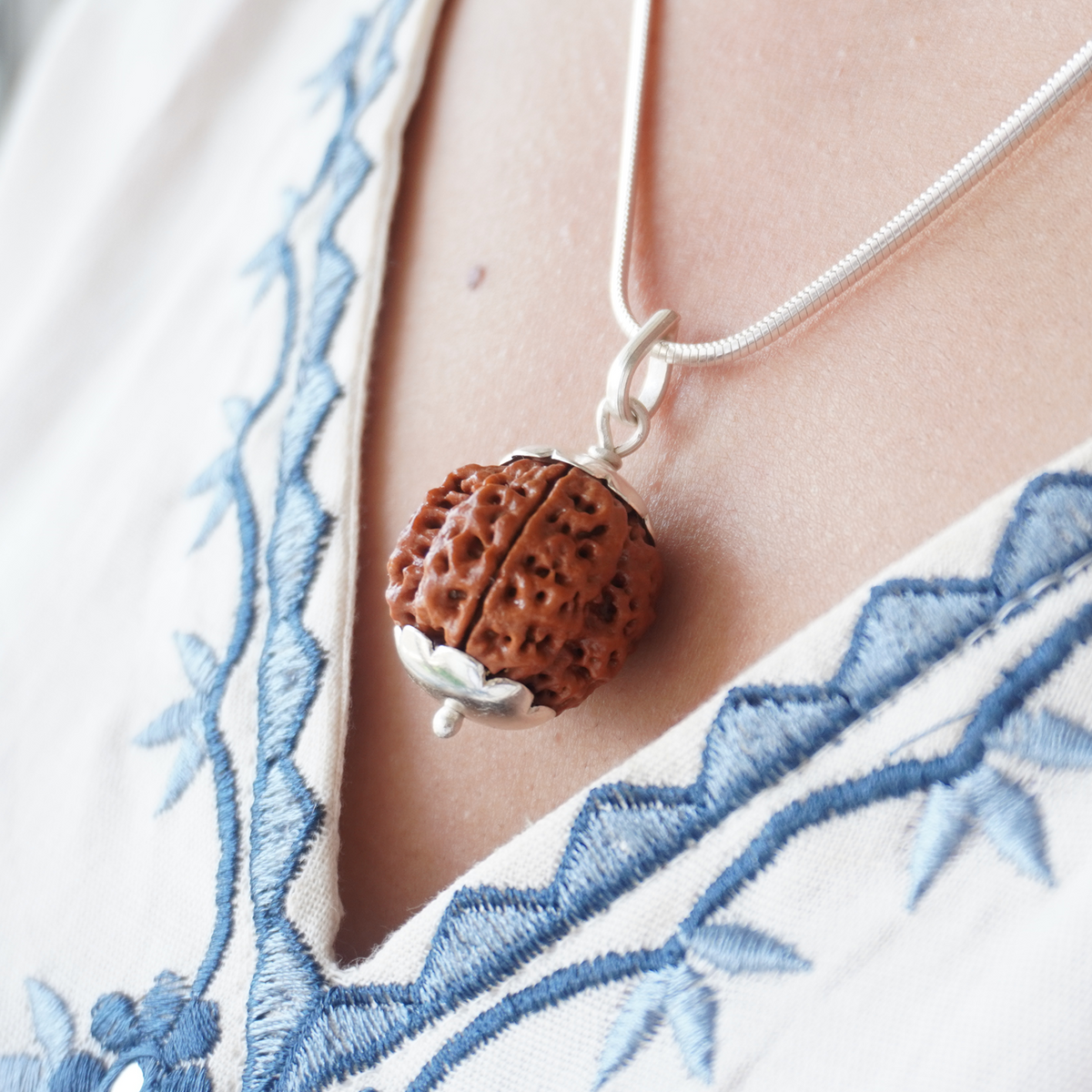 Silver Chain 4 Mukhi Rudraksha pendant worn, close up